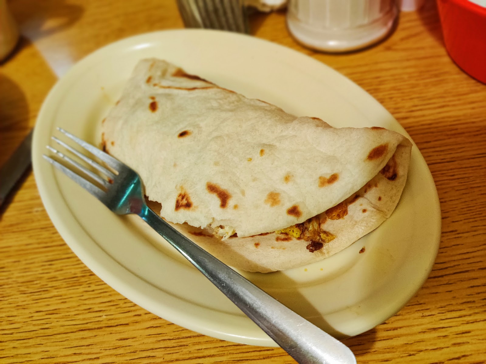 Homemade breakfast taco folded on a plate