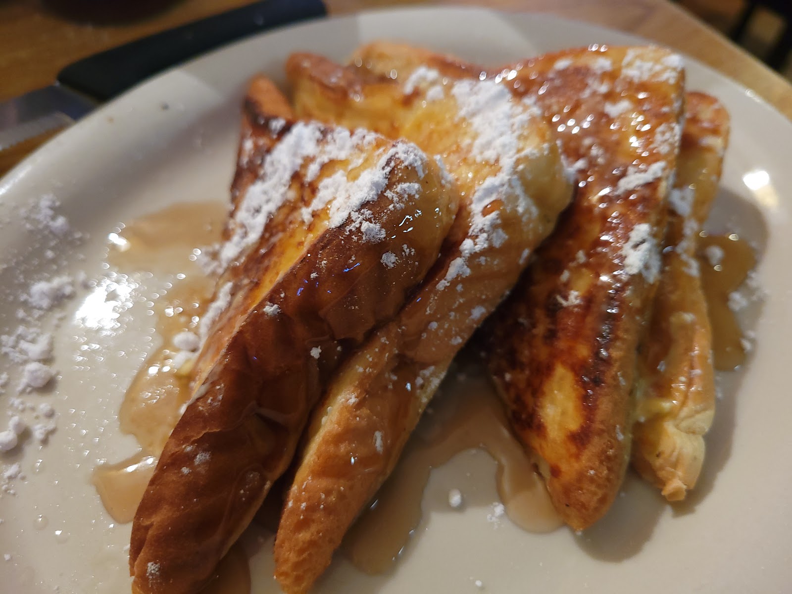 French toast dusted with powdered sugar and syrup
